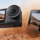 Two DJI Osmo Action 3 action cameras tumbling through the sand.